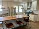 Updated kitchen featuring stainless steel appliances, island seating, and stylish lighting at 5410 E Duncan St, Mesa, AZ 85205