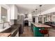 Bright kitchen featuring stainless steel appliances, an undermount sink, and an eat-in island with seating at 5410 E Duncan St, Mesa, AZ 85205