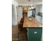 Well-lit kitchen with an island for seating and sliding door access to a pantry at 5410 E Duncan St, Mesa, AZ 85205