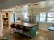 Modern kitchen features an island with seating, and a stainless steel refrigerator at 5410 E Duncan St, Mesa, AZ 85205