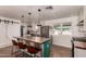 Stylish kitchen featuring stainless steel appliances, pendant lighting, a barn door, and an eat-in island at 5410 E Duncan St, Mesa, AZ 85205