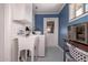 Functional laundry room with sink, washer, dryer, and storage at 5410 E Duncan St, Mesa, AZ 85205