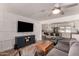 Cozy living room featuring modern furniture, a ceiling fan, and an open view into the kitchen at 5410 E Duncan St, Mesa, AZ 85205