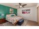 Serene main bedroom featuring a colorful accent wall, a king-size bed, and ample natural light at 5410 E Duncan St, Mesa, AZ 85205
