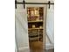 Pantry with sliding barn doors and shelving at 5410 E Duncan St, Mesa, AZ 85205