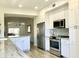 Bright kitchen with white cabinets, stainless steel appliances, and eye-catching backsplash detail at 8653 E Royal Palm Rd # 2010, Scottsdale, AZ 85258