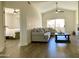 Well-lit living room with hardwood floors, neutral furniture, and sliding glass doors leading to a balcony at 8653 E Royal Palm Rd # 2010, Scottsdale, AZ 85258