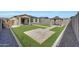 Well-maintained backyard features a gazebo, green lawn and stone borders perfect for outdoor relaxation and entertainment at 129 S 198Th Dr, Buckeye, AZ 85326
