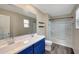 Bathroom featuring double sink vanity, shower over bath, and sleek finishes at 129 S 198Th Dr, Buckeye, AZ 85326