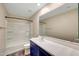Bright bathroom featuring a single sink vanity, shower over bath, and sleek finishes at 129 S 198Th Dr, Buckeye, AZ 85326