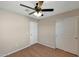 This bedroom features a ceiling fan, wood look floors, and closet for storage at 129 S 198Th Dr, Buckeye, AZ 85326