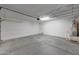 This garage features a water heater with epoxy flooring and ample room for parking and storage at 129 S 198Th Dr, Buckeye, AZ 85326