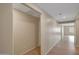 A bright hallway with wood-look flooring leads to another room with abundant natural light at 129 S 198Th Dr, Buckeye, AZ 85326