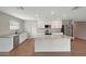 Bright kitchen with island features stainless steel appliances, white cabinets and stone countertops at 129 S 198Th Dr, Buckeye, AZ 85326