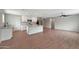 Open-concept kitchen flows to the living room and features white cabinets and island seating at 129 S 198Th Dr, Buckeye, AZ 85326