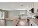 Open kitchen features stainless steel appliances, marble countertops and white cabinetry at 129 S 198Th Dr, Buckeye, AZ 85326
