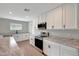 Bright kitchen features stainless steel appliances, white cabinets and stone countertops at 129 S 198Th Dr, Buckeye, AZ 85326
