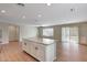Open-concept living room and kitchen area with an island and wood flooring at 129 S 198Th Dr, Buckeye, AZ 85326