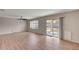 Spacious living room features a ceiling fan, sliding glass door to backyard and wood-look flooring at 129 S 198Th Dr, Buckeye, AZ 85326
