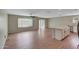 A spacious living room features an island, ceiling fan and wood-look flooring at 129 S 198Th Dr, Buckeye, AZ 85326