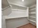 Bright walk-in closet with wooden floor, shelving and a rod for optimal storage at 129 S 198Th Dr, Buckeye, AZ 85326