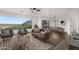 Elegant living room with a curved sofa, natural light, and an open dining area showcasing scenic outdoor views at 36 W Foothill Dr, Phoenix, AZ 85021