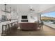 Bright, open living room featuring a modern fireplace, bar seating, and stunning views from the large windows at 36 W Foothill Dr, Phoenix, AZ 85021