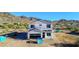 New house with roof tiles, exterior wrap, open garage with mountain views at 3835 W Fox Rd, Laveen, AZ 85339