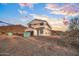 New home exterior with roof tile, wrap, garage, mountain views and desert landscape at 3835 W Fox Rd, Laveen, AZ 85339