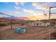 Construction site featuring a home's exterior and desert landscape under a vibrant sky at 3835 W Fox Rd, Laveen, AZ 85339