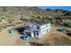 Home with roof tile installation, exterior wrap, open garage and mountain views at 3835 W Fox Rd, Laveen, AZ 85339