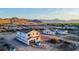New build exterior view with mountain backdrop and initial roof tile installation at 3835 W Fox Rd, Laveen, AZ 85339