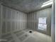 Bright bedroom under construction featuring a large window and drywall at 4309 E Brook Lynn Pl, San Tan Valley, AZ 85143