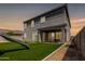 Spacious backyard featuring an outdoor patio area, lush green artificial turf, and a modern design at 4746 S Orbit St, Mesa, AZ 85212