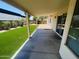 View from the covered patio into the backyard with artificial grass and desert landscaping at 6049 E Glencove St, Mesa, AZ 85205