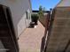 Gated side yard with gravel, exterior AC unit, block wall and view to house windows at 6049 E Glencove St, Mesa, AZ 85205