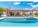 Inviting backyard pool with clear water and a covered patio and bar area for entertaining at 7722 E Hartford Dr, Scottsdale, AZ 85255