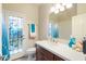 Bathroom featuring a vanity with good storage and a door, blending style and practicality at 7722 E Hartford Dr, Scottsdale, AZ 85255