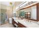 Modern bathroom with double vanity, soaking tub, glass shower and stylish fixtures at 7722 E Hartford Dr, Scottsdale, AZ 85255