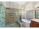 Modern bathroom with glass shower, soaking tub, stylish lighting and fixtures at 7722 E Hartford Dr, Scottsdale, AZ 85255