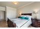 Comfortable bedroom features a bright window and a bed with teal pillows, offering a serene retreat at 7722 E Hartford Dr, Scottsdale, AZ 85255