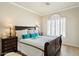 Comfortable bedroom features a bright window and a bed with teal pillows, offering a serene retreat at 7722 E Hartford Dr, Scottsdale, AZ 85255
