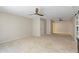 Spacious bedroom featuring neutral carpet, ceiling fan and access to bathroom and closet at 7722 E Hartford Dr, Scottsdale, AZ 85255