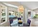 Charming breakfast nook with a glass table, purple chairs, and a view of the backyard pool at 7722 E Hartford Dr, Scottsdale, AZ 85255