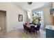 Bright dining room with large windows overlooking the landscaped yard and a modern light fixture at 7722 E Hartford Dr, Scottsdale, AZ 85255