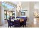 Bright dining room with large windows overlooking the pool and a modern light fixture at 7722 E Hartford Dr, Scottsdale, AZ 85255