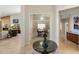 Inviting home foyer showcasing an office with built-in shelves, creating a welcoming and functional space at 7722 E Hartford Dr, Scottsdale, AZ 85255