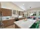Bright kitchen with island, marble counters, modern wood cabinets, and stainless appliances at 7722 E Hartford Dr, Scottsdale, AZ 85255