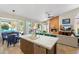 Open-concept kitchen with an island, marble countertops, stainless steel appliances, and views of the backyard at 7722 E Hartford Dr, Scottsdale, AZ 85255