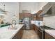 Modern kitchen featuring stainless steel appliances, marble countertops, and wood cabinetry at 7722 E Hartford Dr, Scottsdale, AZ 85255